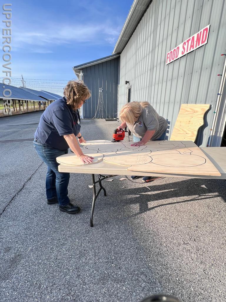 Melissa Pollock and Michele Wickline working on a wooden cut out for our 2022 Egg Hunt 